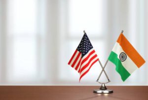 Two crossed national flags on wooden table